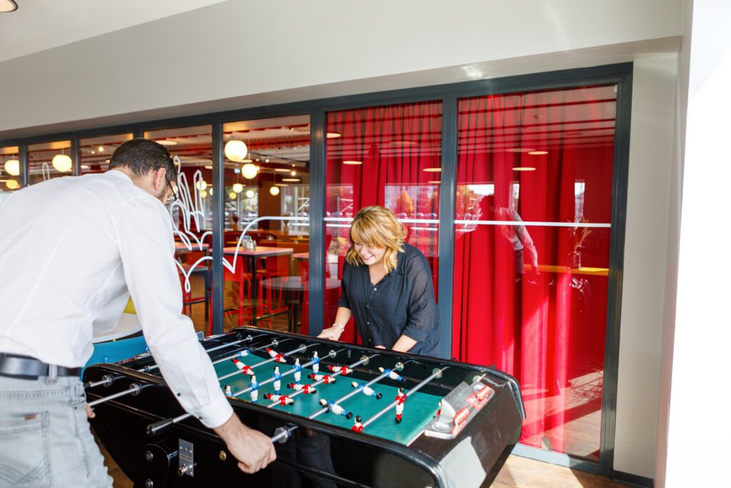 MEININGER Hotel Dresden Zentrum: People playing foosball in the game zone
