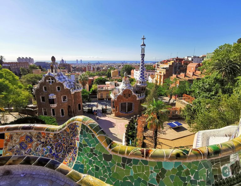 Colorful view over Park Güell and Barcelona cityscape on a sunny budget trip